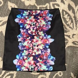 Express black skirt size 6. Floral design in front. Excellent condition. Lined.